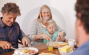 Bonding over breakfast. A cropped shot of a multi-generation family enjoying breakfast together at home.