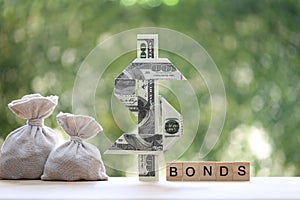 Bonds word with usd dollar money on natural green background, investment and business concept