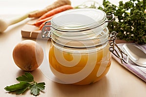 Bone broth made from chicken in a glass jar photo