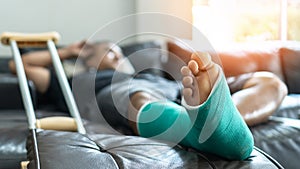 Bone fracture foot and leg on male patient with splint cast and crutches during surgery rehabilitation and orthopaedic recovery