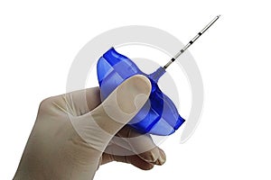 Bone marrow biopsy needle held in palm of doctor left hand in powdered latex glove, white background