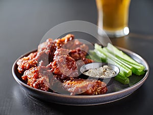 Boneless bbq chicken wings with beer glass in background