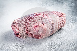 Boneless Leg of Lamb meat on butcher table. White background. Top view