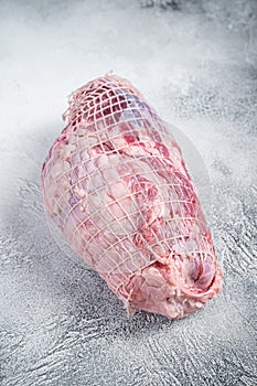 Boneless Leg of Lamb meat on butcher table. White background. Top view
