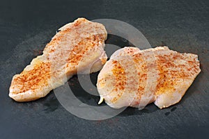 Boneless raw chicken breasts with paprika