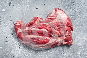 Boneless Raw lamb neck meat on a butcher table. Gray background. Top view
