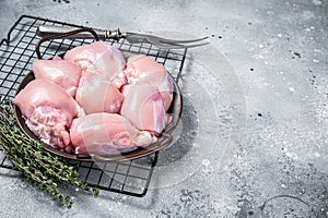 Boneless and skinless Raw Chicken leg thigh fillet. Gray background. Top view. Copy space