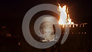 Bonfire on background sea which moon reflected night camping seashore