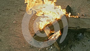 Bonfire burns on the sandy shore