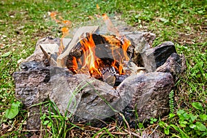 Bonfire in the circle of stones in the forest