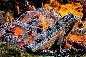 Bonfire close up of the burning logs surrounded my rocks