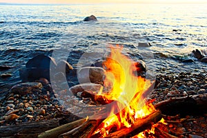 Bonfire at evening lake