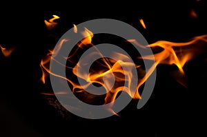 Bonfire with orange flames dark night in a under a blurred background, Flame, heat fire abstract background black background,