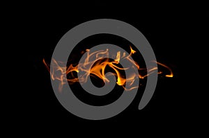 Bonfire with orange flames dark night in a under a blurred background, Flame, heat fire abstract background black background,