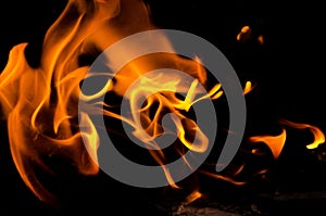 Bonfire with orange flames dark night in a under a blurred background, Flame, heat fire abstract background black background,