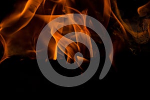 Bonfire with orange flames dark night in a under a blurred background, Flame, heat fire abstract background black background,