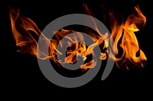 Bonfire with orange flames dark night in a under a blurred background, Flame, heat fire abstract background black background