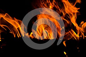 Bonfire with orange flames dark night in a under a blurred background, Flame, heat fire abstract background black background