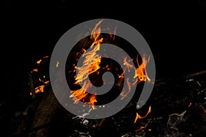 Bonfire with orange flames dark night in a under a blurred background, Flame, heat fire abstract background black background