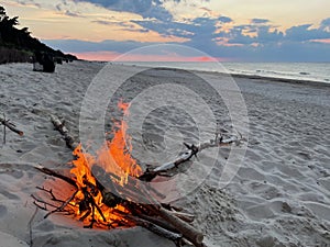 A bonfire by the sea on an empty beach