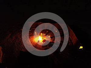 Bonfire among the tents of a Bedouin camp in the Wadi Rum desert, Jordan