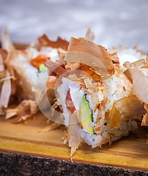 Bonito Maki Sushi - Rolls with Fresh Salmon, Cucumber and Cream Cheese inside. Dried Shaved Bonito outside