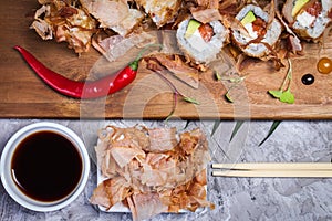 Bonito Maki Sushi - Rolls with Fresh Salmon, Cucumber and Cream Cheese inside. Dried Shaved Bonito outside