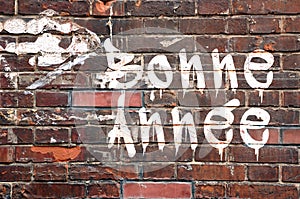 Bonne annee, meaning Happy new Year in French, on a brick wal