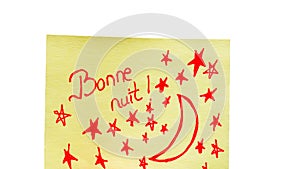 Bonne nuit (good night) handwriting text close up isolated on yellow paper with copy space photo