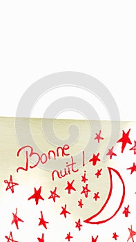 Bonne nuit (good night) handwriting text close up isolated on yellow paper with copy space photo