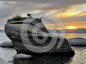 Bonsai Rock on Lake Tahoe against scenic sunset