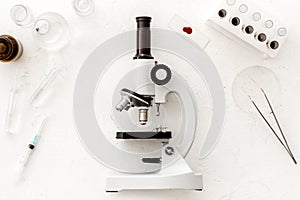 Bood testing with microscope in laboratory. Equipment on white background top view