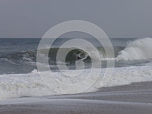 Boogieboarder on a Winter noreaster waves at indian river inlet photo