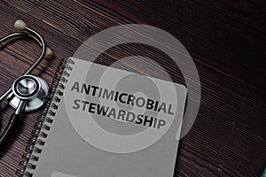 Book about AMS Antimicrobial Stewardship isolated on wooden table