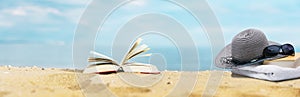 Book on beach with sea in background photo