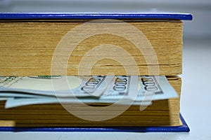Book with a bookmark from dollars