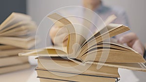 book close-up flipping pages. man reading a book in the library close-up lifestyle. education bookstore concept