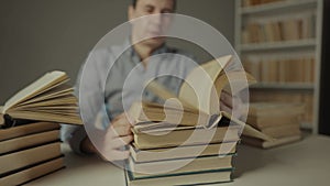 Book close-up flipping pages. Man reading a book in the library. Indoor education bookstore concept. University book