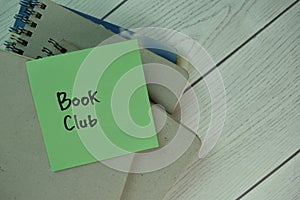 Book Club write on sticky notes isolated on Wooden Table