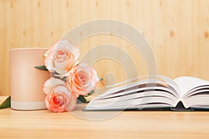 Book and cup with rose flowers - beautiful card about reading or leisure