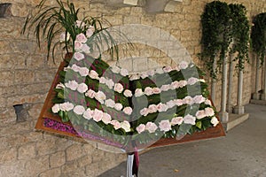 Book decorated with roses with the text of a Gregorian chant of hallelujah