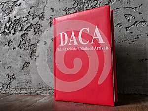 Book Deferred Action for Childhood Arrivals DACA law near the wall.