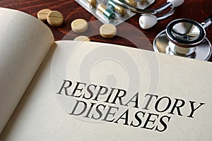 Book with diagnosis respiratory diseases and pills.