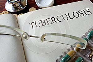 Book with diagnosis tuberculosis and pills.