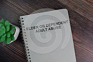 The book of Elder or Dependent Adult Abuse isolated on Wooden Table photo