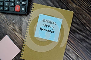 The book of Electrical Safety Handbook isolated on Wooden Table