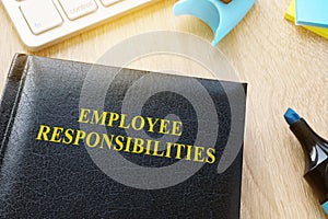 Book about Employee responsibilities on a table.
