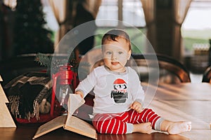 Book examines a little boy sitting on the floor