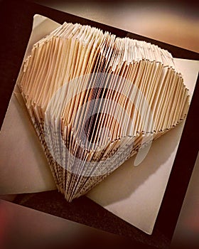 Book folding art heart shaped