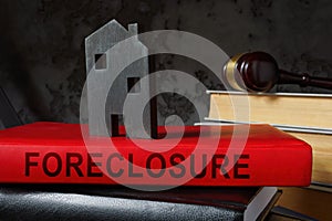 Book about foreclosure and model of house on it.